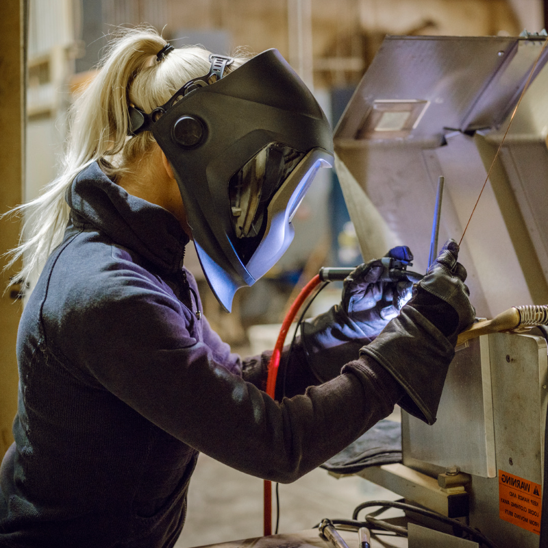 Profile image of blonde-pony-tailed person welding repair machinery A.R.M. action resource management