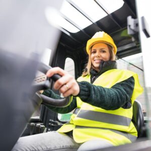 Image of woman forklift driver smiling down at camera. warehouse safety tips forklift safety A.R.M. action resource management