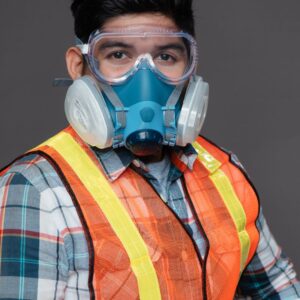 Image of worker wearing PPE - orange safety vest, respirator, and goggles A.R.M. action resource management
