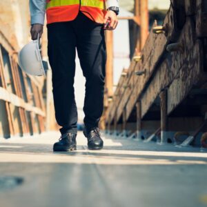 Image of warehouse worker or manager walking towards the camera, focused on their foot wear A.R.M. action resource management