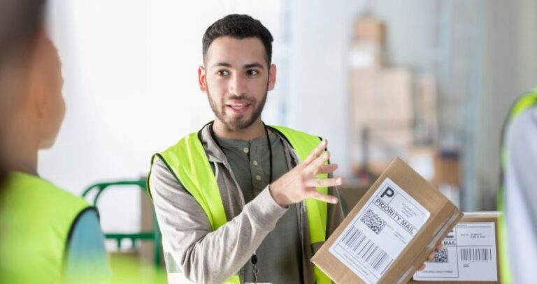 Image of young warehouse worker training or explaining to another worker. training is essential A.R.M. action resource management