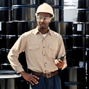 Young warehouse or chemical plant worker wearing hard hat and safety goggles. A.R.M. action resource management