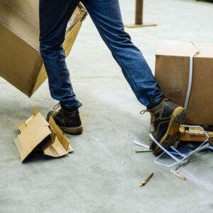 Image of warehouse worker's legs and feet as they trip over objects left in the way for keeping a clean workspace A.R.M. action resource management