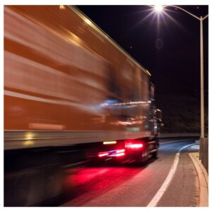 Image of truck driving at night, motion-blurred. A.R.M. action resource management