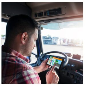 Image of man truck driver checking his truck driver's GPS device while seated in his truck. A.R.M. action resource management
