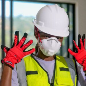 Image shows a warehouse worker wearing PPE - a white hard hat and breathing mask, orange gloves and a yellow vest. A.R.M. Action Resource Management.
