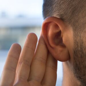This image shows a person holding their fingers behind their ear, indicating that they cannot hear and/or are trying to hear. For Protect your hearing. A.R.M. Action Resource Management. OSHA Safety training.