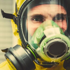 Image of a worker wearing PPE, including yellow hazard suit and full-face mask. A.R.M. action resource management