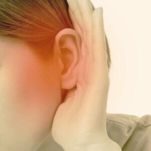 This image shows a person with their hand cupped behind their ear, with a red hue over the ear area, indicating hearing loss. A.R.M. Action Resource Management. Safety training.