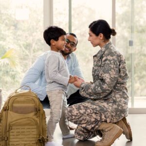 This image shows a family of three: a small boy, a father, and a soldier mother. It appears the mother is leaving home to report for duty. A.R.M. Action Resource Management