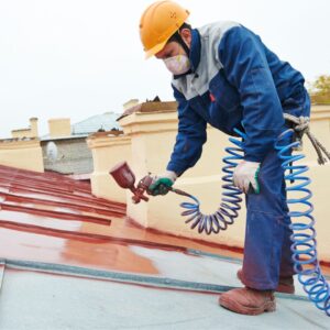 This image shows a man worker dressed in boots, gloves, heavy clothing, mask and hard hat, as he works with paint and tiles. Winter safety tips for outdoor workers. Action Resource Management A.R.M.