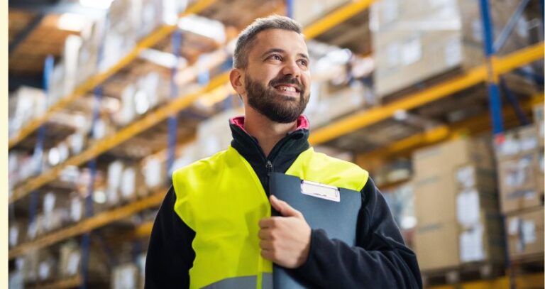 An image of a smiling male warehouse worker. Safety first.