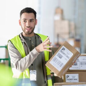 A young man warehouse worker reviewing safety techniques