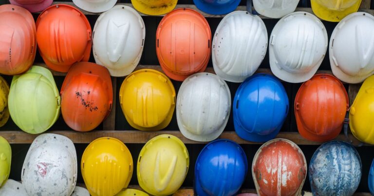 A collection of different colored safety helmets for Stay Safe: Top 10 Tips for Warehouse Workers