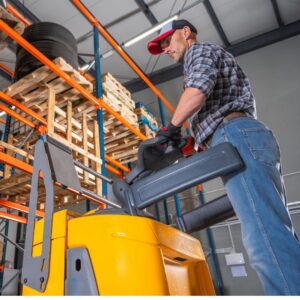 A warehouse worker operating a forklift properly and safely. Workplace Ergonomics: How to Prevent Musculoskeletal Injuries