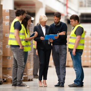 Warehouse staff meeting; boss communicating with warehouse staff.