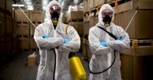 Image of two warehouse workers wearing PPE to avoid accidental poisoning. Poison Prevention: Essential Tips for Warehouse Safety