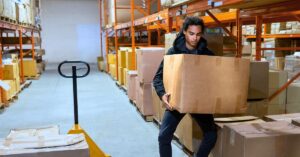 A warehouse worker moving a box. Lift Smart, Work Safe: Proper Techniques to Prevent Injuries