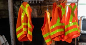 Safety vests hanging at the warehouse. Essential Warehouse Safety Tips: Preventing Accidents and Protecting Workers