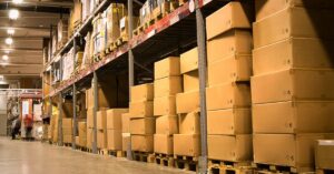 An image of boxes on warehouse shelves. Stay Sharp: Prevent Workplace Complacency