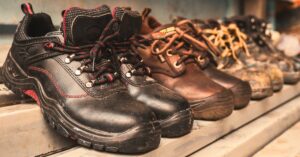 A row of various work boots. Protect Your Feet on the Job: Safe Footwear for Warehouse Workers
